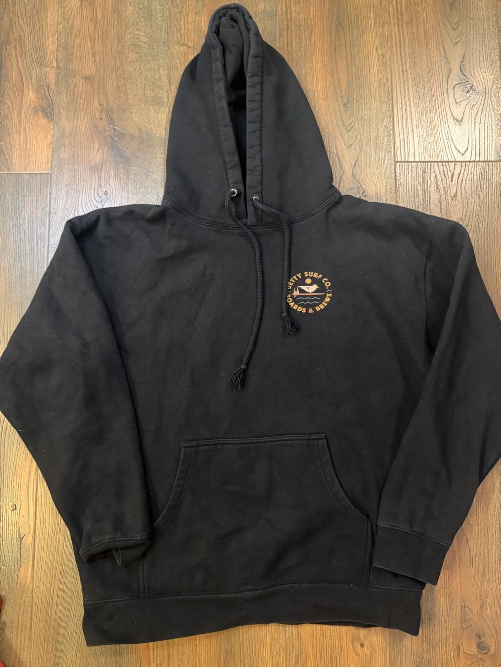 Jetty Black Pullover Hoodie with front and back logo- coastal surfer vibes